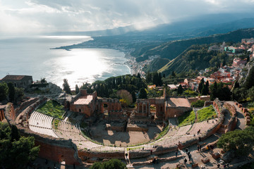 The ancient Greek theatre of Taormina seen from above during a sunny day. Aerial drone shot
