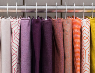 coloured fabric is shown hanging on a rack