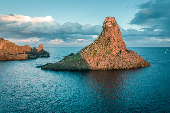 Top view of Aci Trezza, Lachea Island and the Ciclope Stacks at sunset. Sicily, Italy