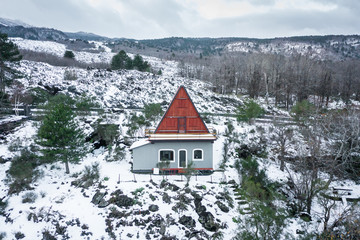 Beautiful mountain chalet seen from above, aerial drone shot