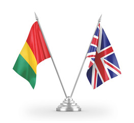 United Kingdom and Guinea table flags isolated on white 3D rendering