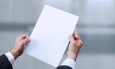 hand holding blank paper