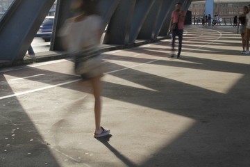 People crossing a bridge in Bilbao