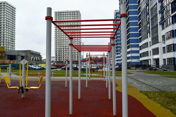 A new modern safe outdoor workout area with exercise equipment for sports in the new district of the city in the courtyard of the new building