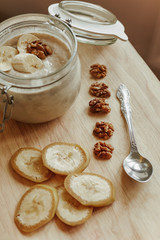 Breakfast made from natural yogurt and bananas with walnuts. Healthy food in the morning.