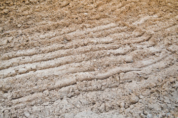 View of brown cracked natural moist earth clay. The background. Texture