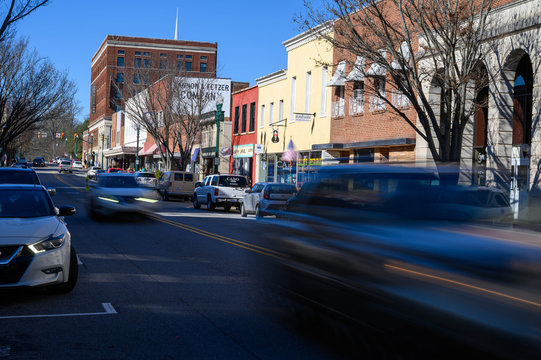Looking down Union Street in downtown Concord NC. The blurred cars move down the main street.