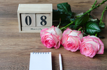 pink rose natural flowers on wooden background, gift for March 8 holiday