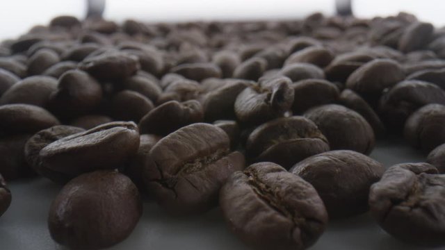 Macro extreme close up of coffee beans falling