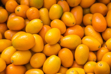 An abundance of kumquats for sale on a market stall