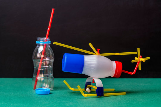 DIY toy helicopter made of waste and plastic bottles. Recycle crafts.