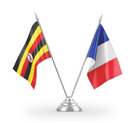 France and Uganda table flags isolated on white 3D rendering