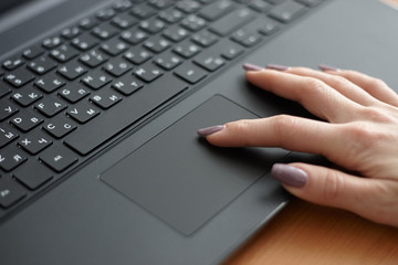 Female using black laptop for working. surfing internet using touchpad. business concept.