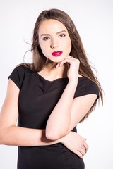 Beautiful young African American woman in black dress isolated over white background
