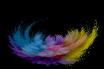 Colored powder explosion. Abstract closeup dust on backdrop. Colorful explode. Paint holi