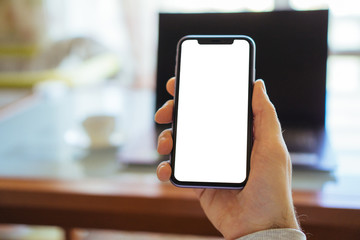 Gelendzhik, Russia -   January 18, 2020: Hands of an man use Iphone 11. Mock up image blank white screen cell phone. Men manual texting using mobile background empty ad space.