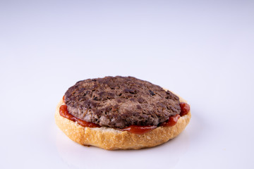  phased assembly of a hamburger on a light background