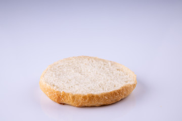  phased assembly of a hamburger on a light background