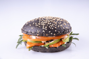  burger with black dough and salmon on a light background2