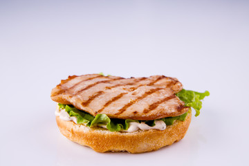  phased assembly of a hamburger on a light background
