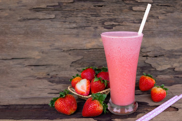 Strawberry yogurt fruit juice smoothie pink colorful fruit juice milkshake blend beverage healthy high protein the taste yummy In glass drink episode morning on wood background.