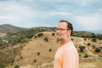 Middle age man tourist admiring landscape of Cap de Creus, National Park on the Costa Brava, Spain