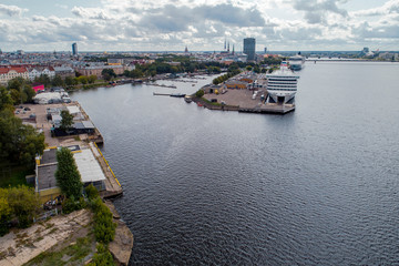 Aerial View of multiple yachts and boats in the dock. Large cruise ship in background.