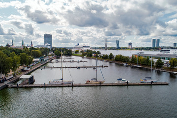 Naklejka premium Aerial View of multiple yachts and boats in the dock. Large cruise ship in background.