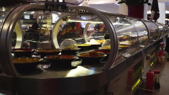 Outer Corner View With Door Open Of A Sushi Converyor Belt In A Japanese Restaurant Rotating With Delicious Food