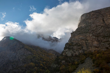 Fototapeta na wymiar Overcast in mountains. Beautiful mountain rocks in clouds. Landscape of the North Caucasus