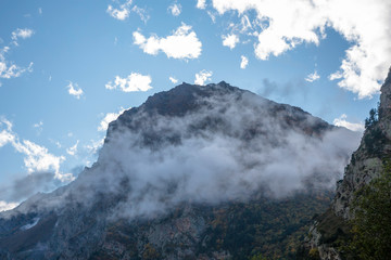 Overcast in mountains. Beautiful mountain rocks in clouds. Landscape of the North Caucasus
