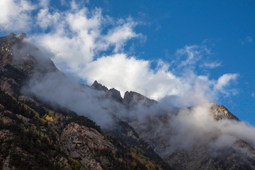 Fototapeta na wymiar Overcast in mountains. Beautiful mountain rocks in clouds. Landscape of the North Caucasus