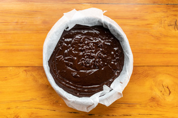 Chocolate cake dough in a tin ready to go in the oven