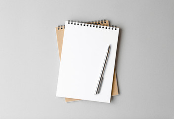 open notebook with pen on a gray background