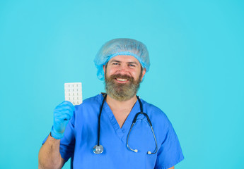 Doctor with pills. Medicine. Nurse. Package of pills. Treatment pill. Pharmaceutical drug. Bearded doctor. Smiling doctor with pills.