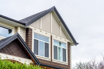 The top of the house or apartment building with nice window.