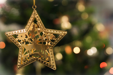 Golden Christmas Star on blur bokeh Background
