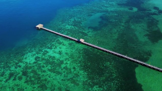 Turquoise water with wooden pier in Labuan Bajo