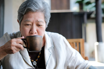old elderly senior elder woman drinking coffee tea. mature retirement lifestyle