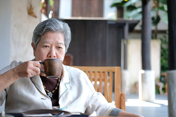old elderly senior elder woman drinking coffee tea. mature retirement lifestyle