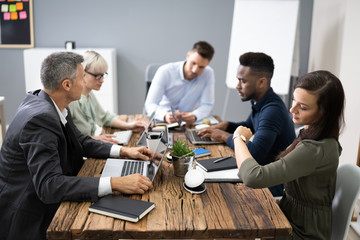 Woman Checking Time While Sitting In A Meeting