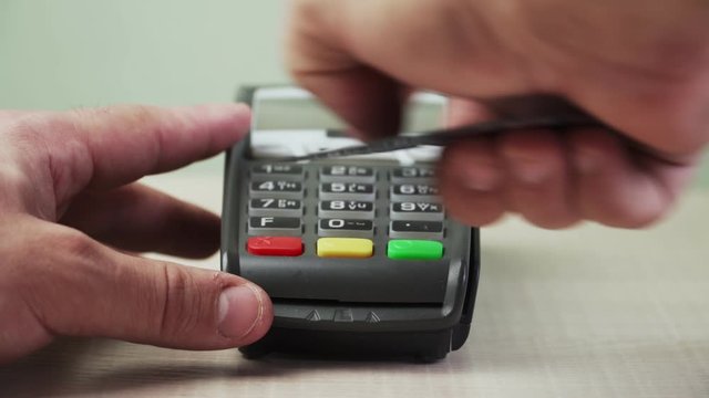 Payment via Bank terminal card. Close-up. Cashless settlement