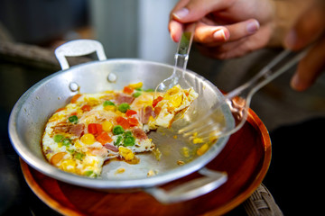 Fried eggs pan cooked from egg and corn carrots bacon ham and lantau nuts are a popular breakfast menu in Thailand Restaurant 