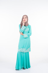 Beautiful female Muslim model in various poses wearing modern kurung and hijab, a modern lifestyle apparel for Muslim women isolated on white. Beauty and hijab fashion concept. Full length portrait