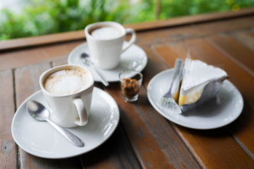 Coffee cup and cake top view on wooden table background