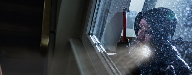 Burglar Looking Into A House Window