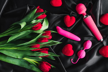 Various sex toys set on a black background. Advertising a sex shop. The view from the top. Spring....