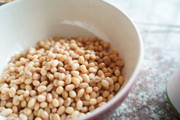 Soybean in hand and soak in water 3 hours before make soy milk.
