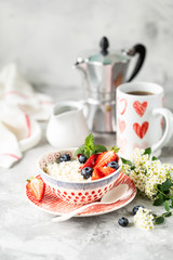 Cottage cheese with berries, jam, fresh strawberries and a cup of coffee with cream for breakfast. The recipe for the holiday Valentine's Day. Copy space