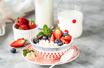 Cottage cheese with fresh strawberries and milk for breakfast. The recipe for the holiday Valentine's Day. close-up